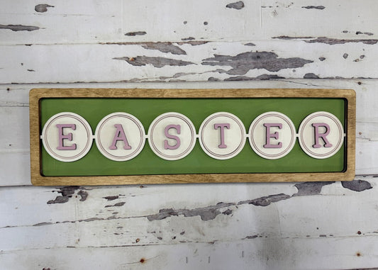 Wooden sign with 'EASTER' letters on a green background against a rustic wooden wall.